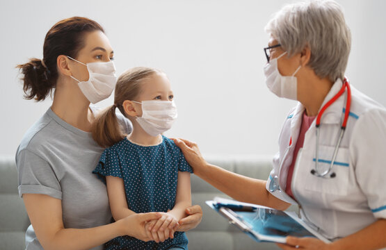 Doctor, Child And Mother Wearing Facemasks