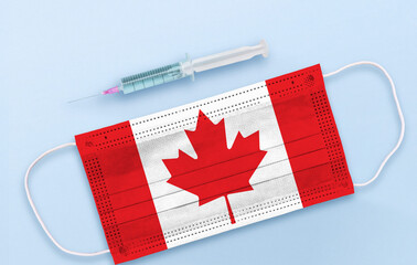 Flag of Canada on Medical protective Surgical mask and vaccine. Coronavirus vaccine and vaccination concept.