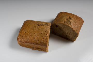 Cut loaf of zucchini bread on a white background