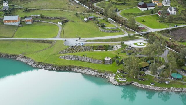 Aerial View of Village and Green Landscape by Glacial Fjord Lake Water, Norway. Oldevatnet, Drone Shot