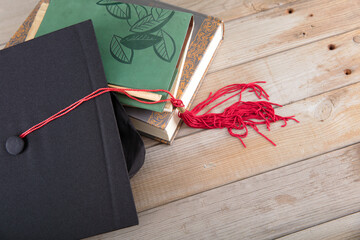 Looking down on a stack of books and a doctor's hat on the table