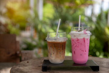 Cold milk smoothie  milkshake and ice latte coffee in take awa and has sunlight a nature background.. - obrazy, fototapety, plakaty