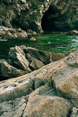 Rocks and grotto on the seashore, cloudy weather at sea, coastline of telyakovsky Bay Primorsky Krai, Russia.