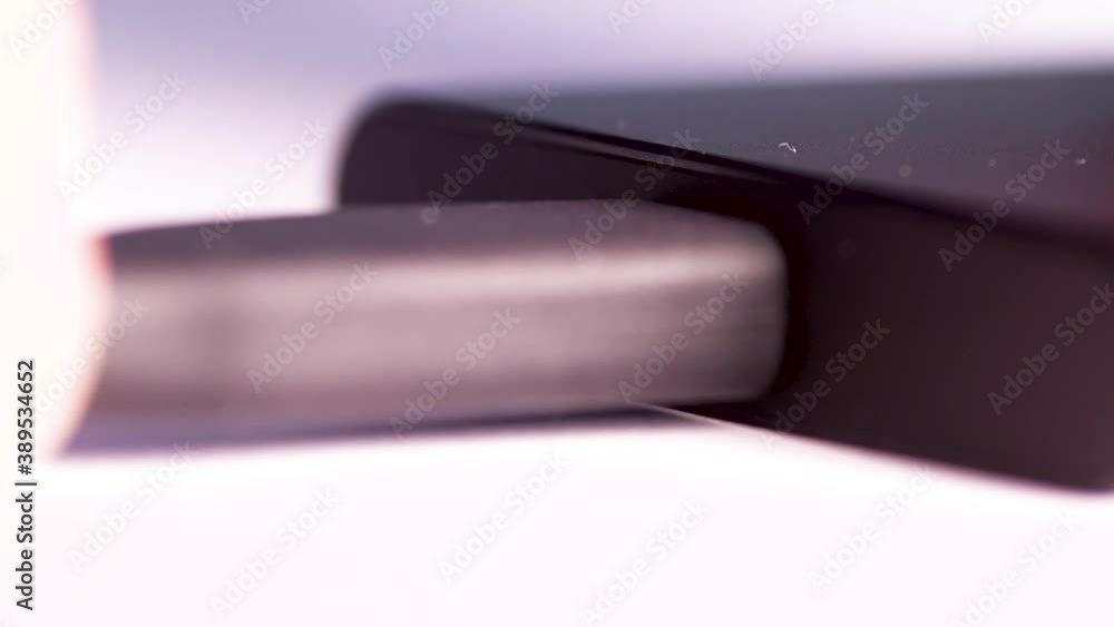 Poster close up of a man's hand plugging in an android usb external hard drive