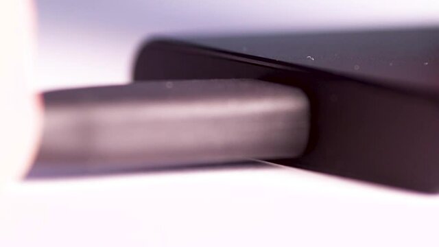 Close up of a man's hand plugging in an android USB external hard drive