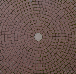 Red paving slabs laid in circles
