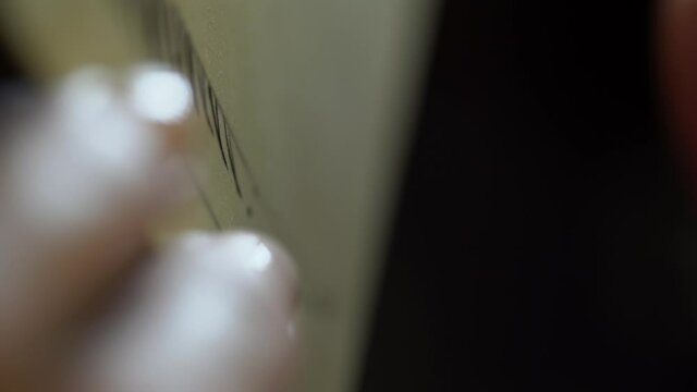 Close-up of female beautician hand drawing eyebrows on sketch board. Microblading course.