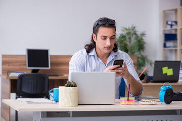 Young male businessman employee working in the office