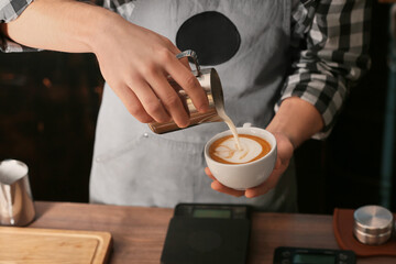 Fototapeta na wymiar Barista making hot coffee in cafe, closeup