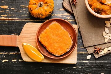 Plate with tasty bread and pumpkin jam on table