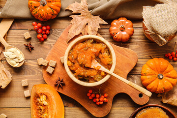 Obraz na płótnie Canvas Autumn composition with tasty pumpkin jam on wooden background