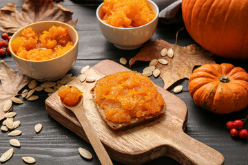 Sandwich with tasty pumpkin jam on table