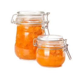 Jars of tasty pumpkin jam on white background