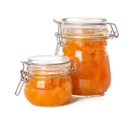 Jars of tasty pumpkin jam on white background