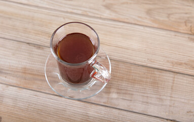 A cup of freshly brewed hot coffee on the table
