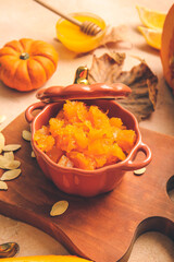 Pot of tasty pumpkin jam on table