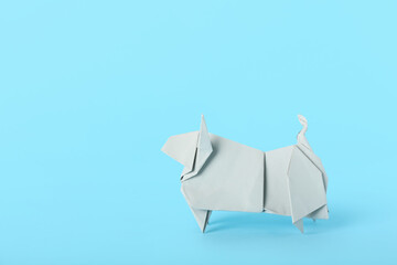 Origami bull as symbol of year 2021 on color background