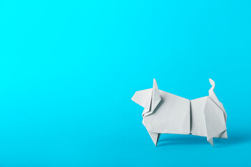Fototapeta premium Origami bull as symbol of year 2021 on color background