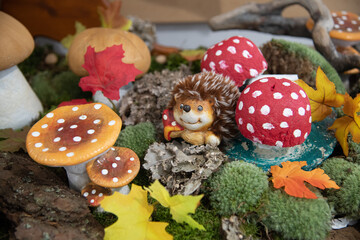 hedgehog and mushroom figurines in a garden decoration