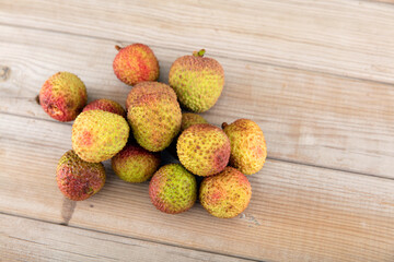 There is a bunch of fresh lychees on the table