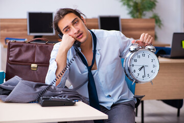 Young male employee being late for his job