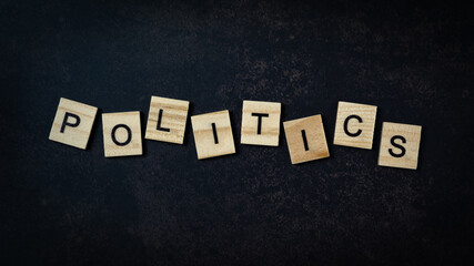 The politics lettering on the small wooden cube. top view shots.