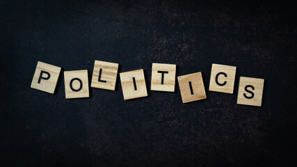 The politics lettering on the small wooden cube. top view shots.