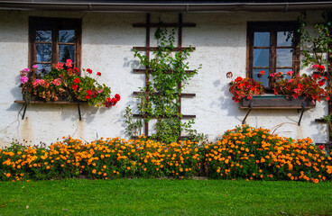 facade of a traditional farmhouse with flower decoration in the Austria region of Carinthia