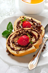 Cake Roulade with chocolate and strawberries on the white background