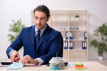 Young male financial manager in the office