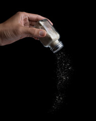 Pepper powder in glass bottle isolated on black background,pepper shaker