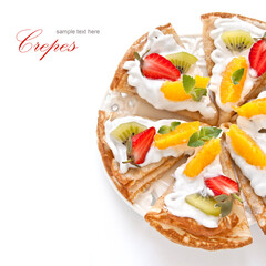Crepes with soft cream, strawberries, kiwi, oranges and mint