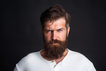 Obraz premium Young handsome man with long beard, mustache and trendy hairdo.