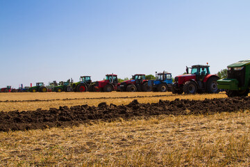 Agricultural tractor plowing a field