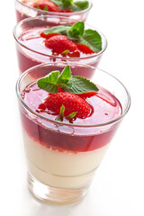 Milk Jelly with strawberry in the glass topped mint leaf