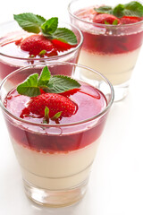 Milk Jelly with strawberry in the glass topped mint leaf