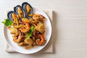 stir-fried spiral pasta with seafood and basil sauce