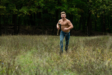Lumberjack muscled young man run. Shirtless athletic naked guy running, nature outside.