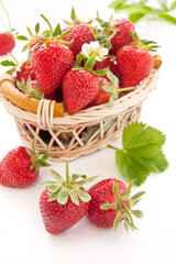 Ripe strawberries in the basket on a white background