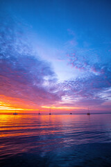 Fototapeta premium Sunset sea beach. Blue sea and reflection of sunlight.