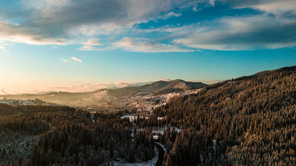 Carpathian mountains winter. Snow coniferous forest at sunset.