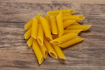 Raw penne pasta for bowl