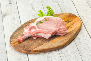 Raw pork bone steak over wooden