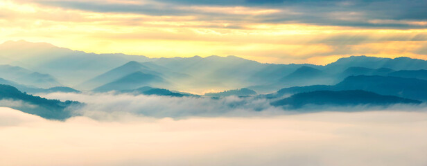 Fototapeta na wymiar Panorama view of mountain and fog with sun rays in morning sunrise, Beautiful landscape of natural
