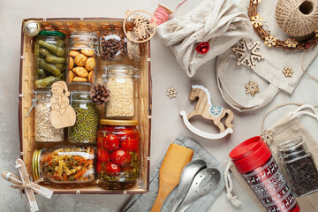 Fototapeta na wymiar Products food in jars in a gift basket. Top view. Donation concept. Zero waste