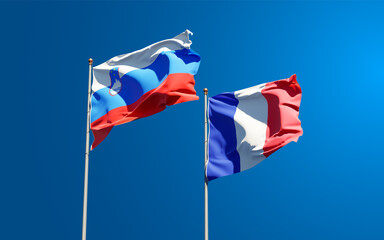 Beautiful national state flags of France and Slovenia together at the sky background. 3D artwork concept.