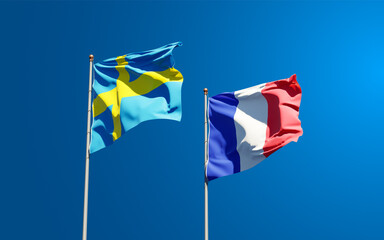 Beautiful national state flags of France and Sweden together at the sky background. 3D artwork concept.