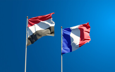 Beautiful national state flags of France and Yemen together at the sky background. 3D artwork concept.