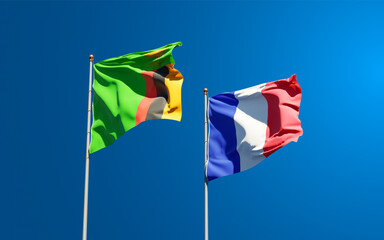 Beautiful national state flags of France and Zambia together at the sky background. 3D artwork concept.