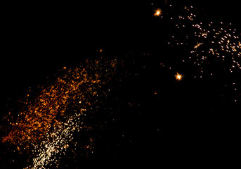 blurry sparks from fireworks on black background